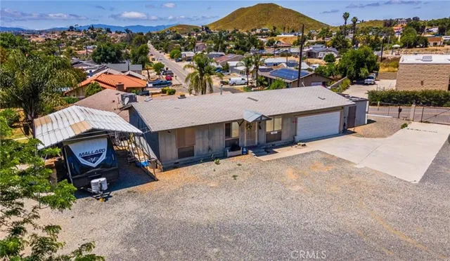 an aerial view of a house with a yard
