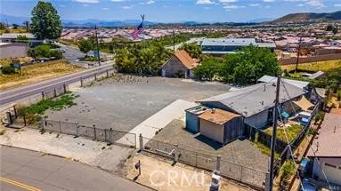 an aerial view of a house with a yard and a large tree