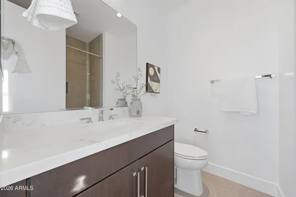 a bathroom with a sink a toilet and mirror