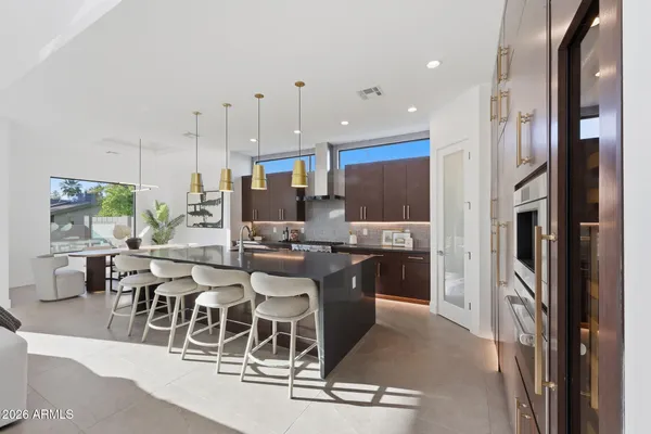 a kitchen with stainless steel appliances kitchen island granite countertop a refrigerator and cabinets