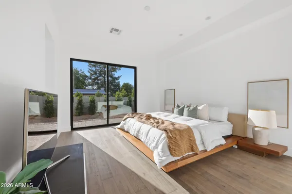 a bedroom with a bed and a large window