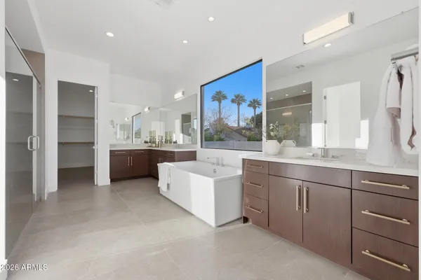 a large bathroom with a large mirror vanity and sink