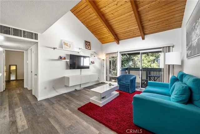 a living room with furniture fireplace and a large window