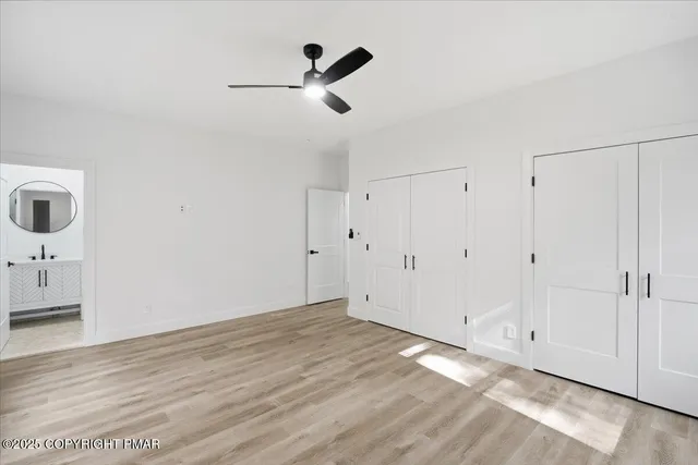 a view of a big room with wooden floor and windows