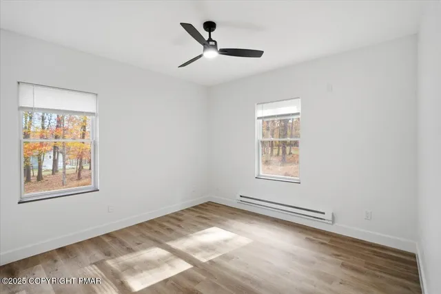 a view of a room with wooden floor