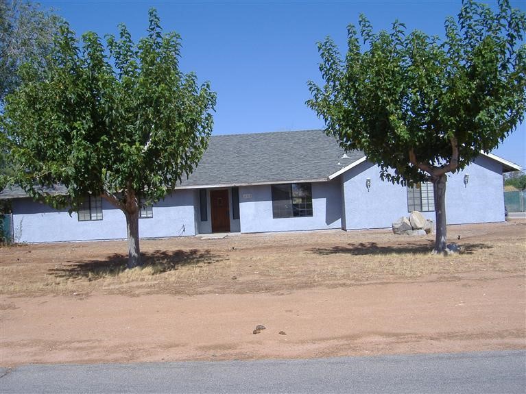 14510 Hopi Road Apple Valley, CA 92307 - Photo 1 of 1 a front view of a house with a yard