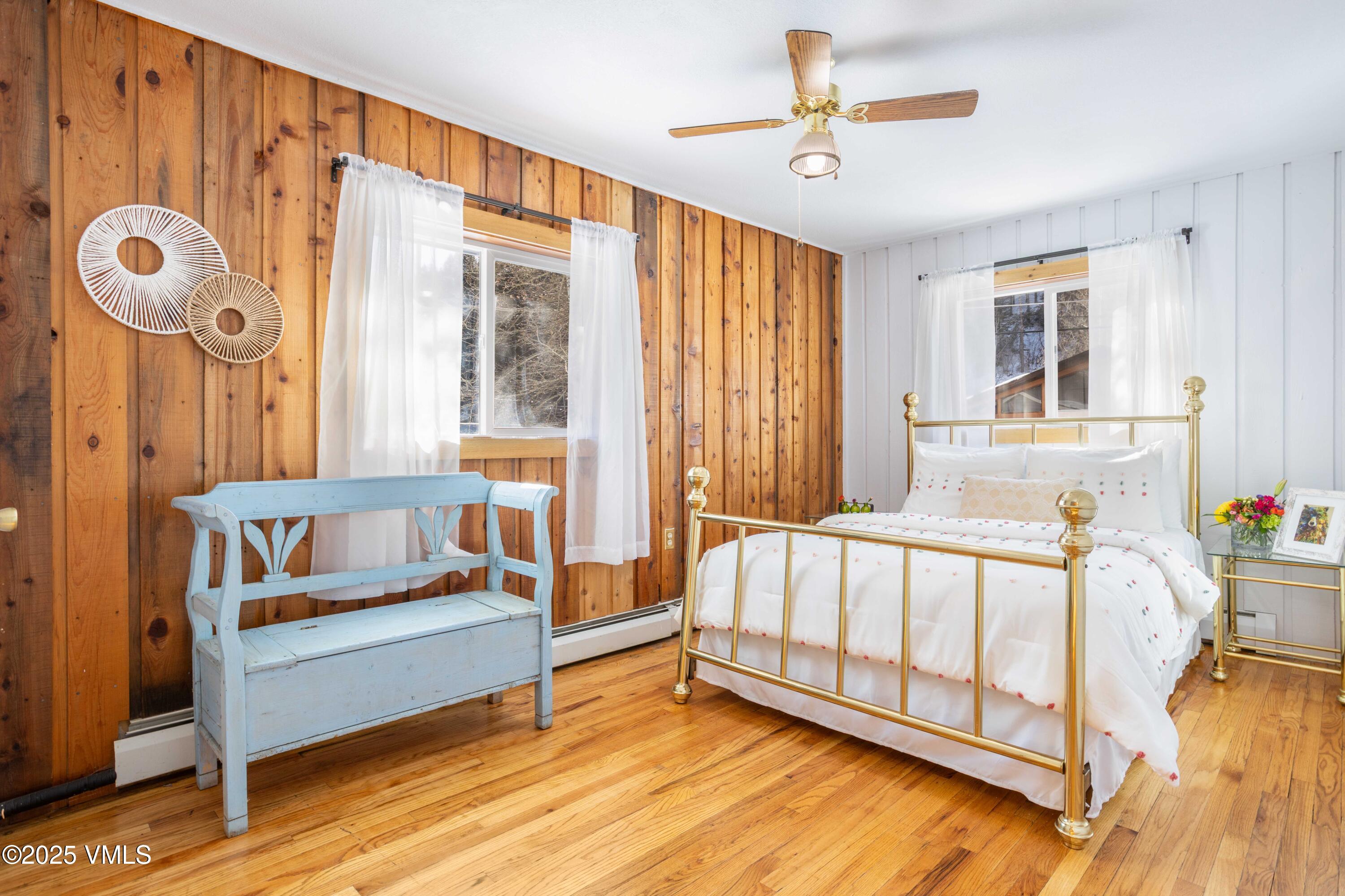 561 Main Street Minturn, CO 81645 - Photo 15 of 29 a spacious bedroom with a bed and a chandelier