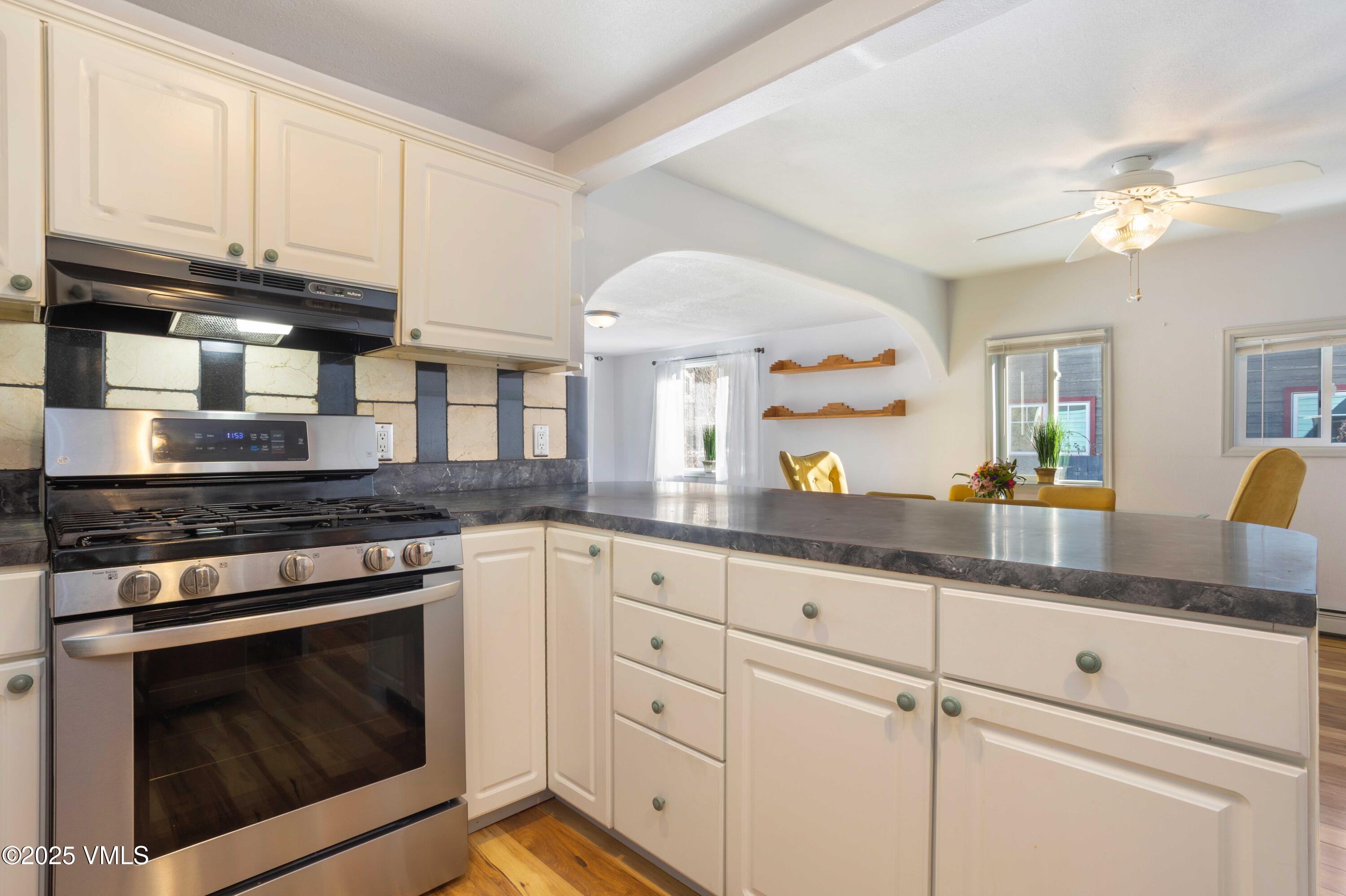 561 Main Street Minturn, CO 81645 - Photo 7 of 29 a kitchen with granite countertop cabinets stainless steel appliances and a counter space
