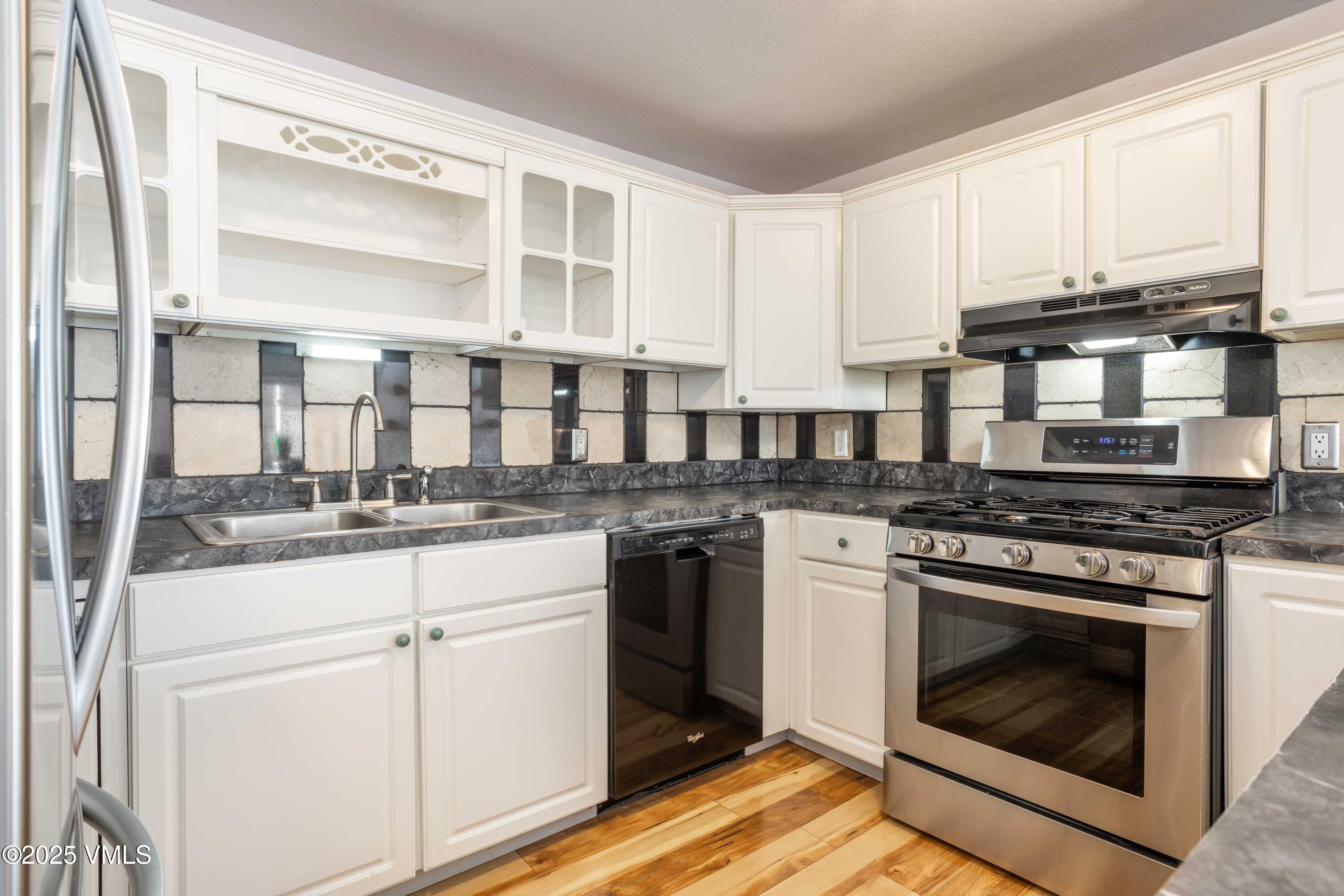 561 Main Street Minturn, CO 81645 - Photo 8 of 29 a kitchen with stainless steel appliances granite countertop a stove and a white cabinets