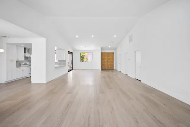 a view of an empty room and wooden floor