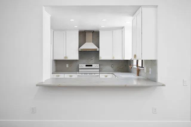 a view of kitchen with stainless steel appliances granite countertop refrigerator sink and stove