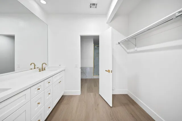 a bathroom with a double vanity sink and mirror
