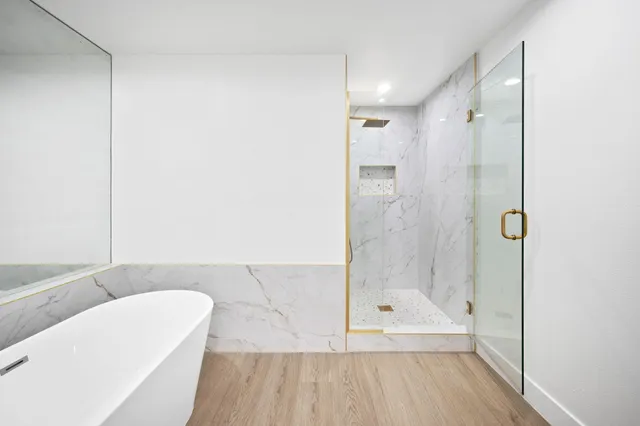 a bathroom with a bathtub and a shower
