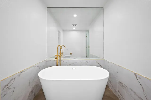 a white bath tub sitting in a bathroom
