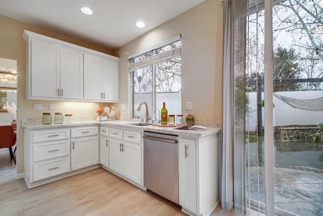 a kitchen with a stove a sink and a refrigerator