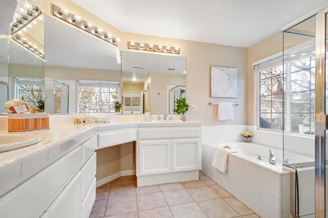 a large white kitchen with a large window