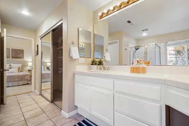 a bathroom with a sink a mirror and a shower