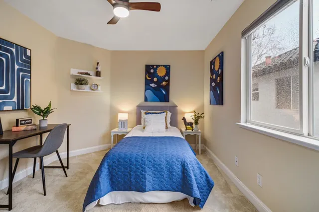 a bed room with a bed and a chair