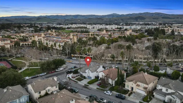 an aerial view of houses with a street