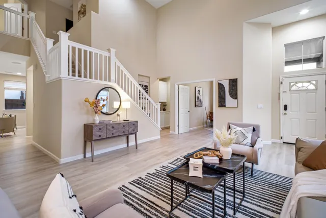 a living room with furniture and wooden floor