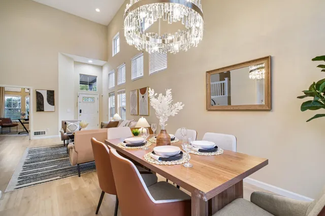 a view of a dining room with furniture and chandelier