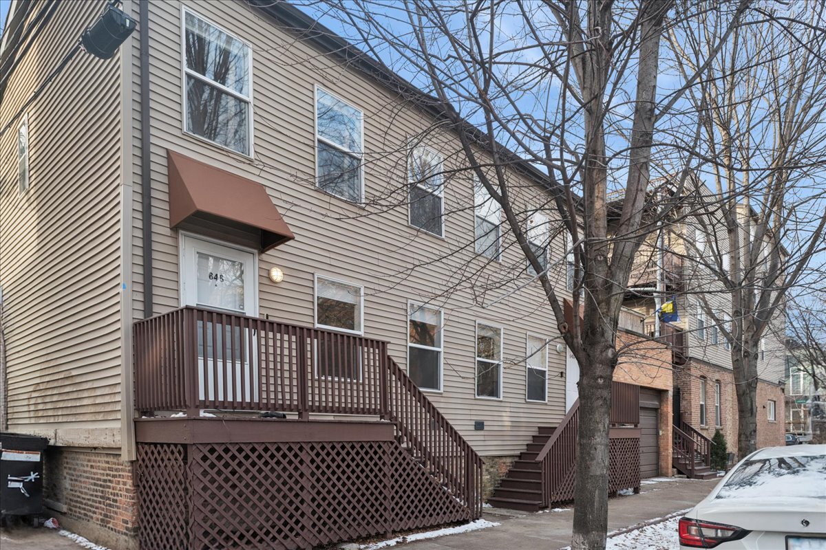 648 North Bishop Street, Unit S Chicago, IL 60642 - Photo 1 of 23 a front view of a house with a yard