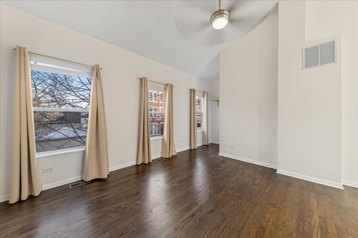 648 North Bishop Street, Unit S Chicago, IL 60642 - Photo 13 of 23 an empty room with wooden floor and windows