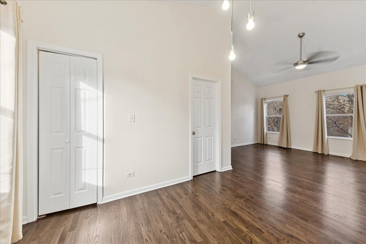 648 North Bishop Street, Unit S Chicago, IL 60642 - Photo 14 of 23 a view of an empty room with a window and wooden floor