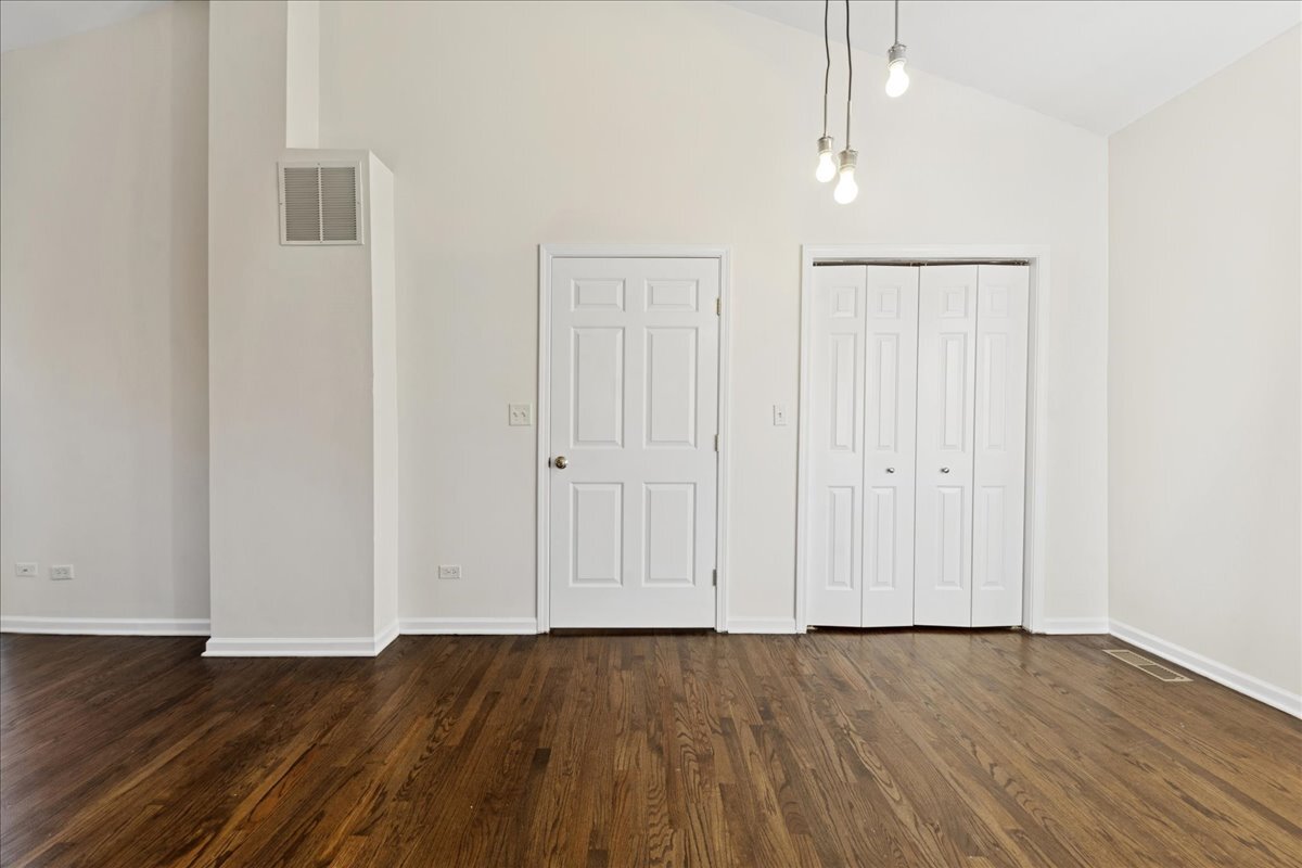 648 North Bishop Street, Unit S Chicago, IL 60642 - Photo 15 of 23 a view of an empty room with wooden floor