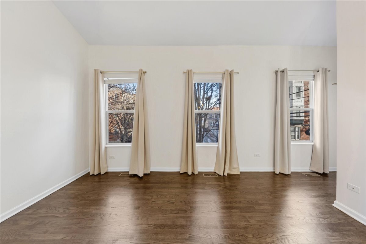 648 North Bishop Street, Unit S Chicago, IL 60642 - Photo 16 of 23 an empty room with wooden floor and windows