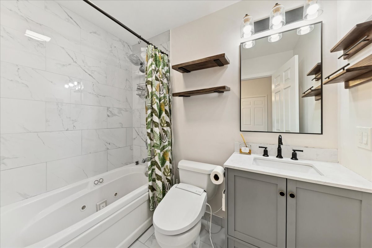 648 North Bishop Street, Unit S Chicago, IL 60642 - Photo 17 of 23 a bathroom with a sink toilet and shower