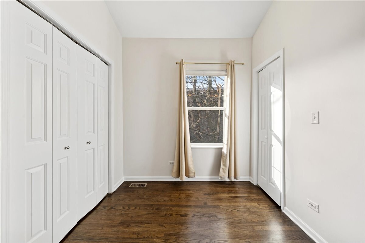 648 North Bishop Street, Unit S Chicago, IL 60642 - Photo 19 of 23 a view of an empty room with wooden floor and a window