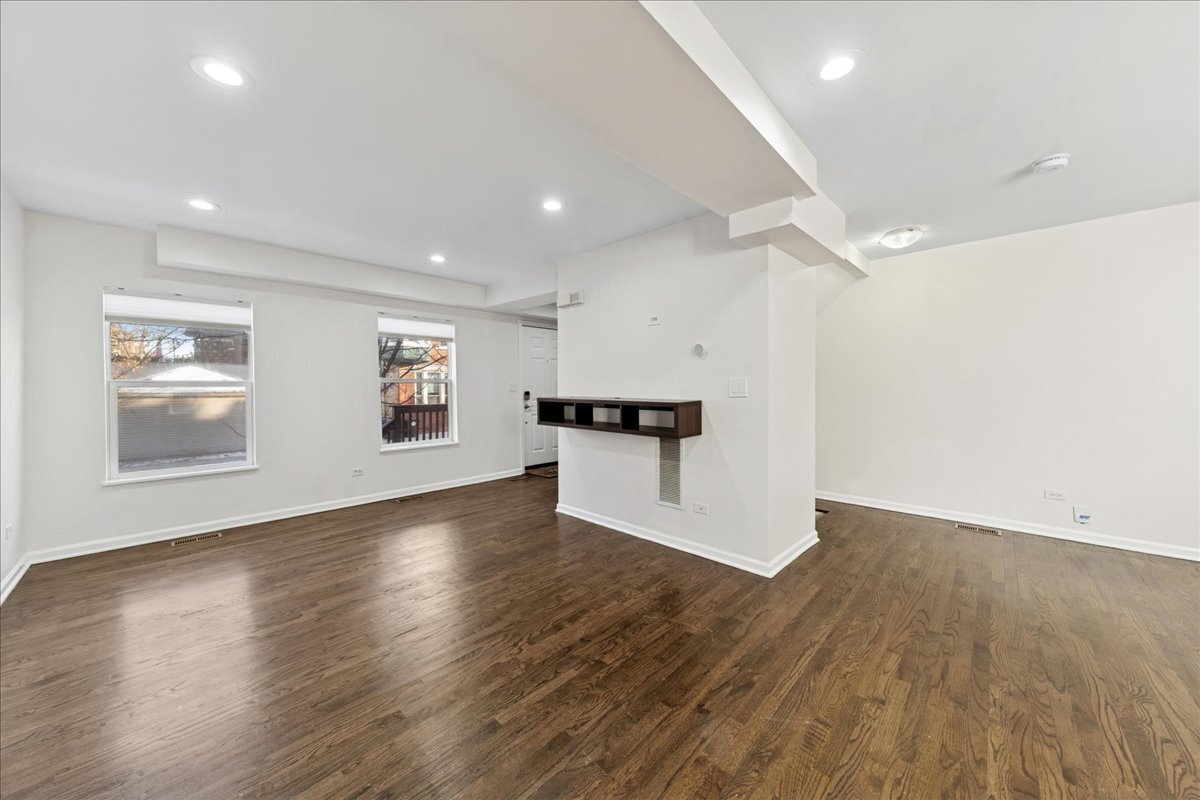 648 North Bishop Street, Unit S Chicago, IL 60642 - Photo 2 of 23 a view of an empty room with wooden floor and a window