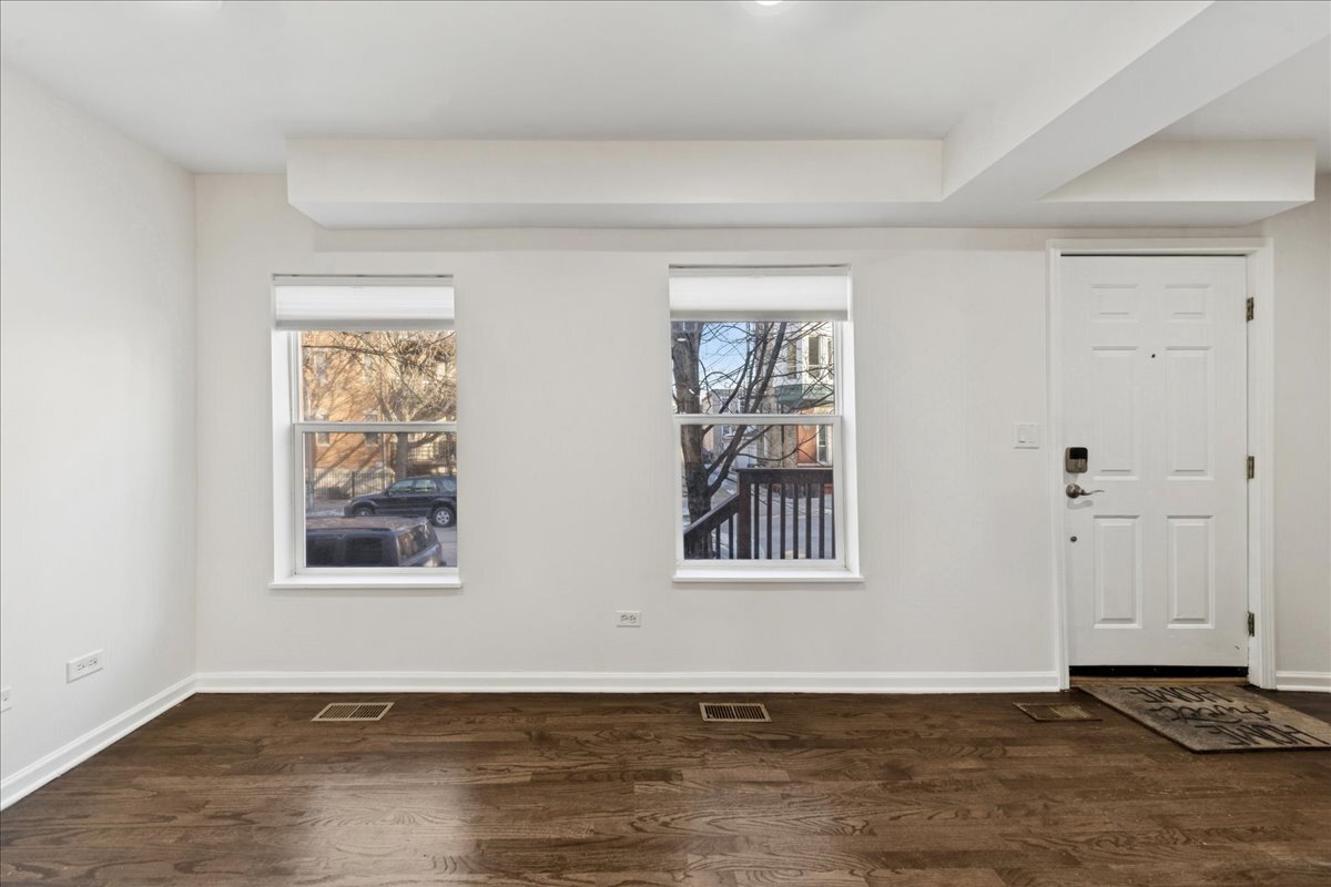 648 North Bishop Street, Unit S Chicago, IL 60642 - Photo 4 of 23 an empty room with wooden floor and windows