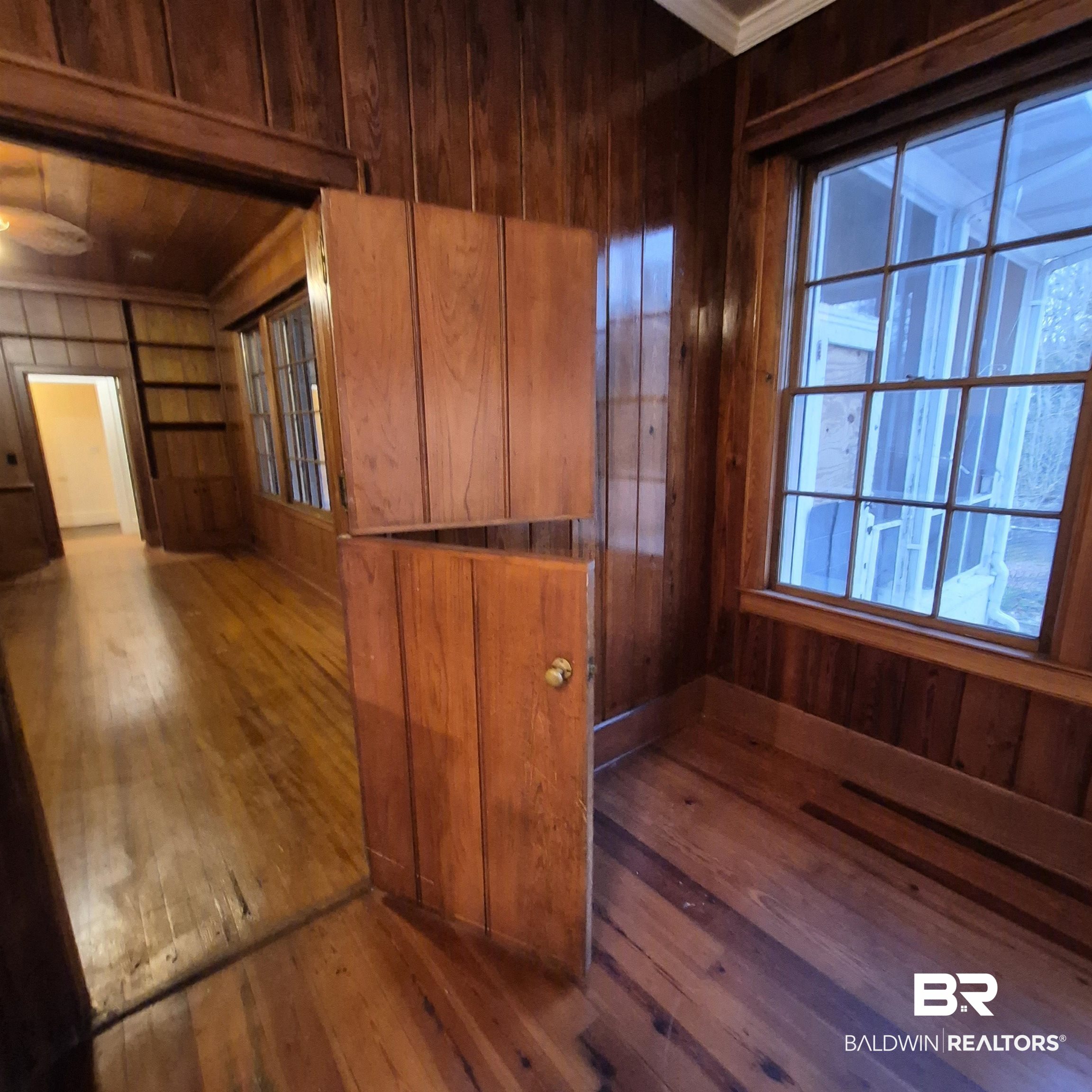 308 Rural Street Evergreen, AL 36401 - Photo 23 of 40 Spare room featuring wooden walls and dark wood-type flooring