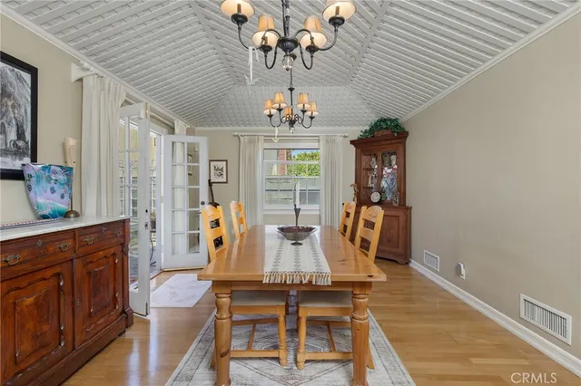 a view of a dining room with furniture wooden floor and chandelier