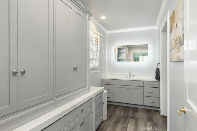 a bathroom with a double vanity sink toilet and shower
