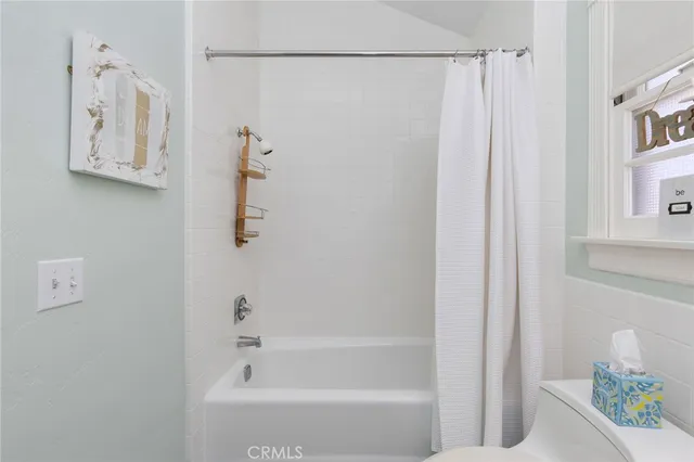 a bathroom with a shower and a bath tub