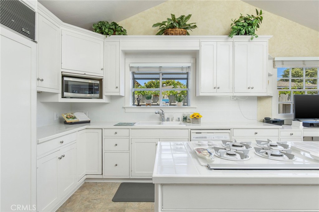 4124 East 5th Street Long Beach, CA 90814 - Photo 28 of 38 a kitchen with stainless steel appliances white cabinets and a stove