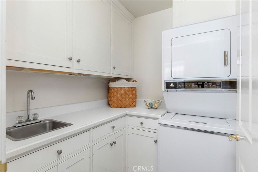4124 East 5th Street Long Beach, CA 90814 - Photo 34 of 38 a kitchen with cabinets and white appliances