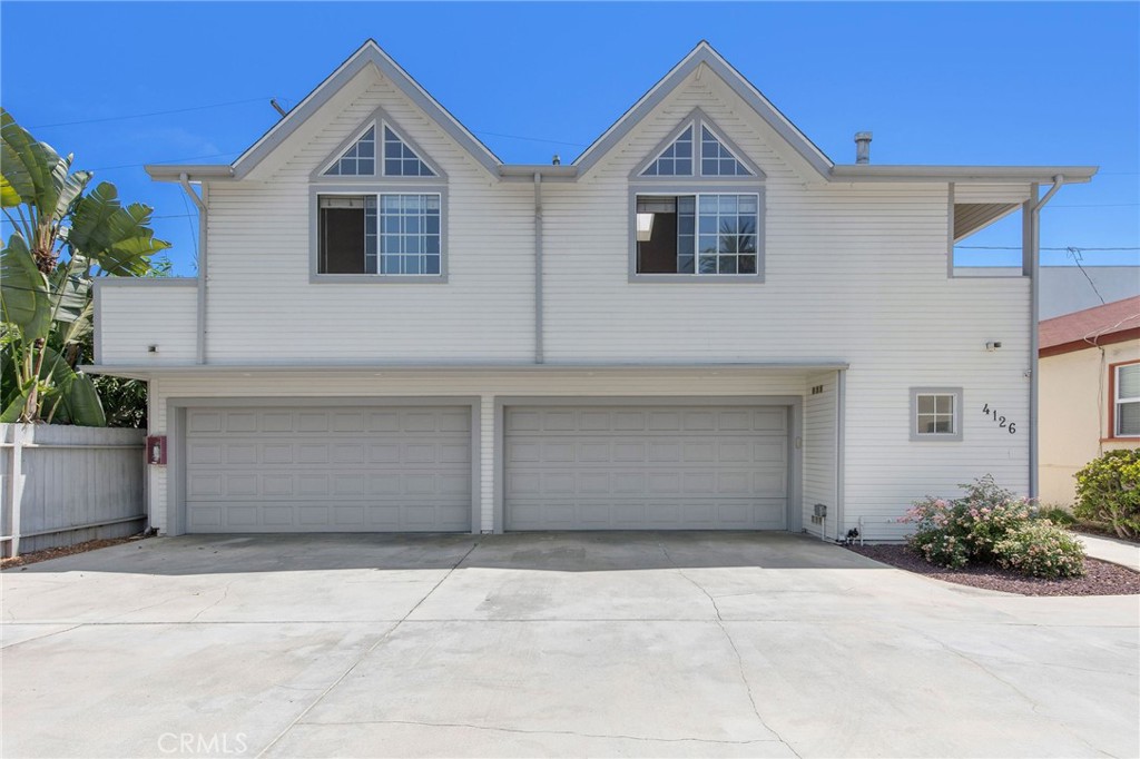 4124 East 5th Street Long Beach, CA 90814 - Photo 35 of 38 a front view of a house with a yard and garage