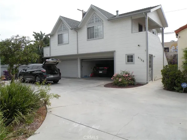 a view of a house with a yard and sitting area
