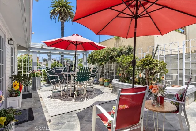 a view of a patio with a table and chairs under an umbrella
