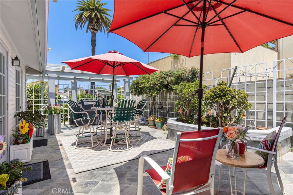 4124 East 5th Street Long Beach, CA 90814 - Photo 7 of 38 a view of a patio with a table and chairs under an umbrella