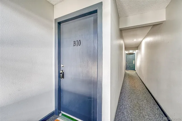 a view of hallway with wooden floor