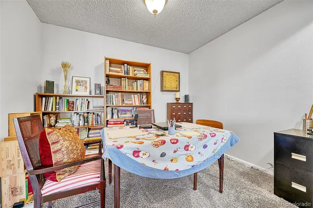 a bedroom with a bed and a bookshelf in it