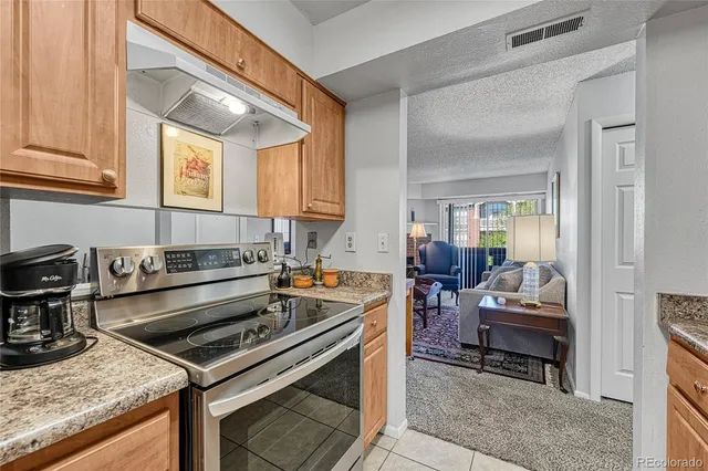 a kitchen with a stove a sink and a refrigerator