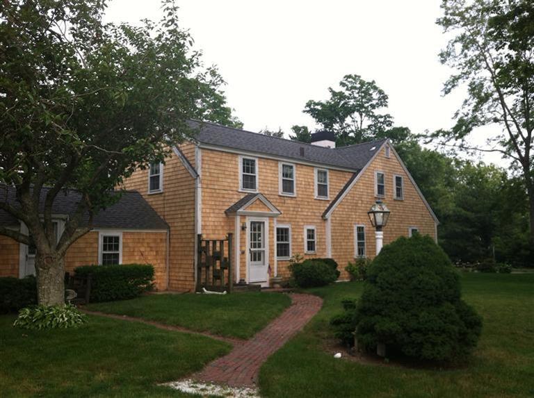10 Dyer Prince Road Eastham, MA 02642 - Photo 3 of 27 front view of a house next to a yard