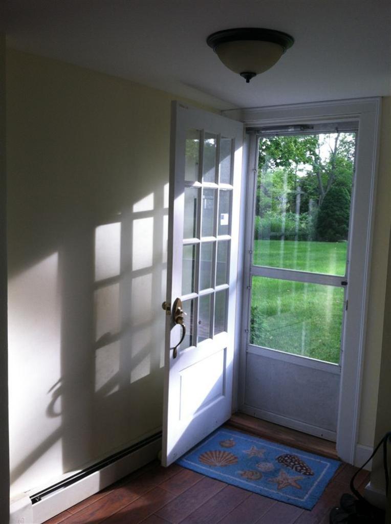 10 Dyer Prince Road Eastham, MA 02642 - Photo 5 of 27 a hallway with a large window and wooden floor