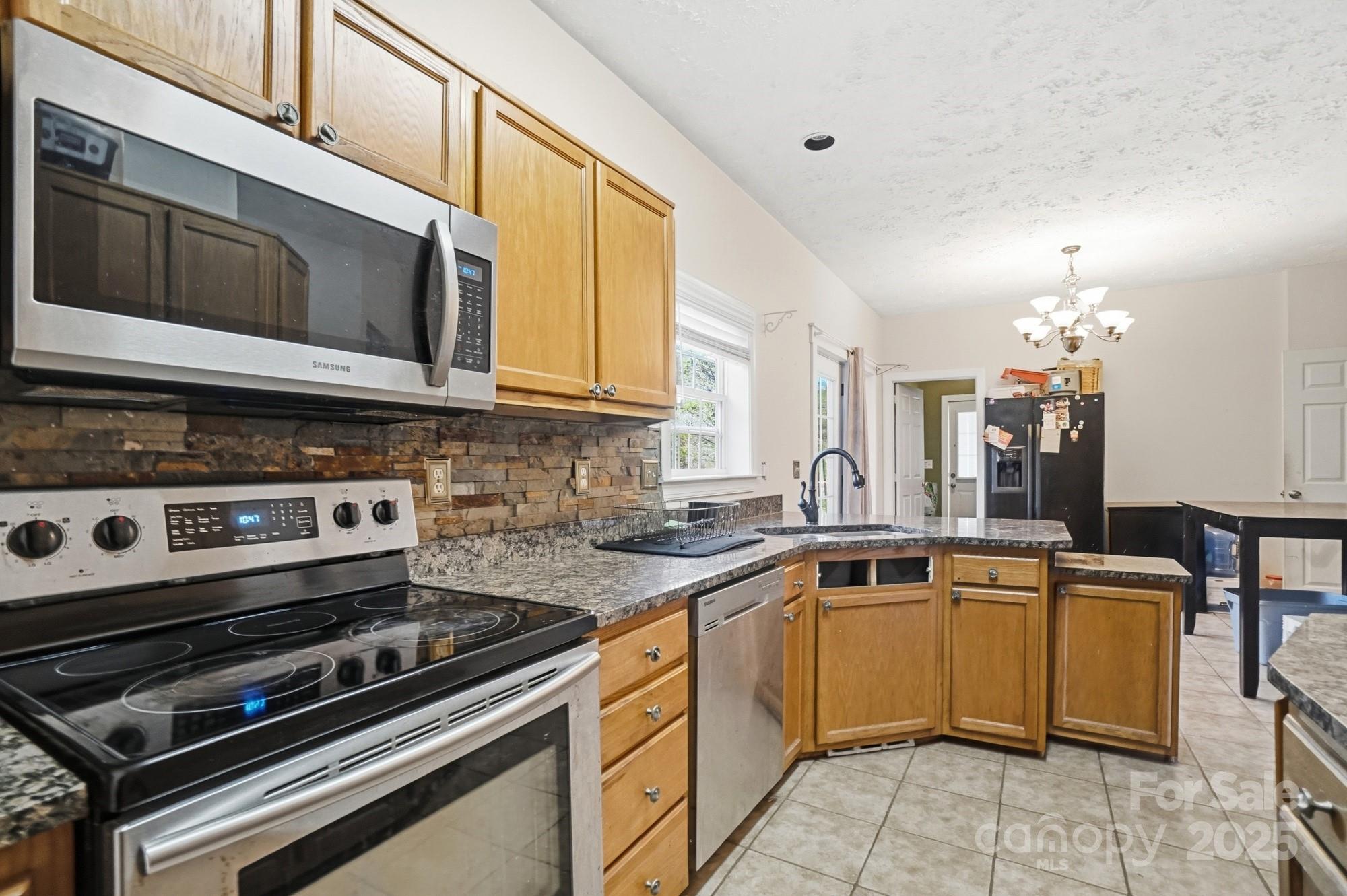 218 Fulbright Road Stony Point, NC 28678 - Photo 11 of 47 a kitchen with a stove and a microwave